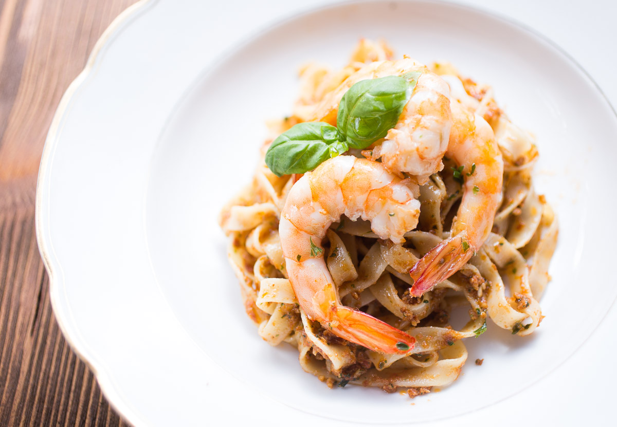 Tagliatelle with red pesto and king prawns